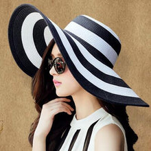 Load image into Gallery viewer, Black and white striped straw hat along the beach

