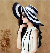 Load image into Gallery viewer, Black and white striped straw hat along the beach
