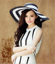 Load image into Gallery viewer, Black and white striped straw hat along the beach
